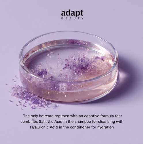 Glass container with purple powder on a light purple background, featuring Adapt Beauty branding.