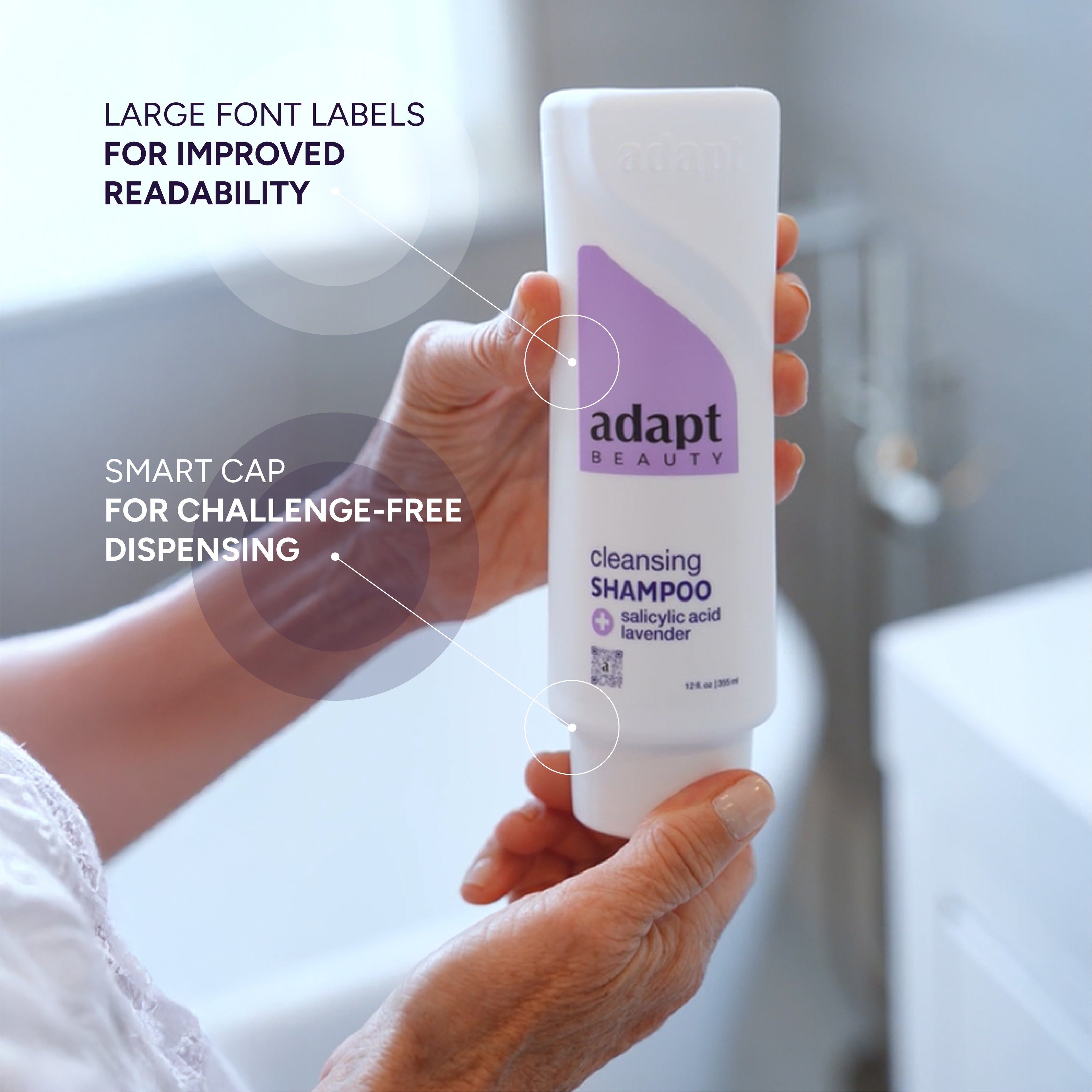 Hand holding a bottle of 'adapt beauty' cleansing shampoo with text highlighting features like large fonts and challenge-free dispensing