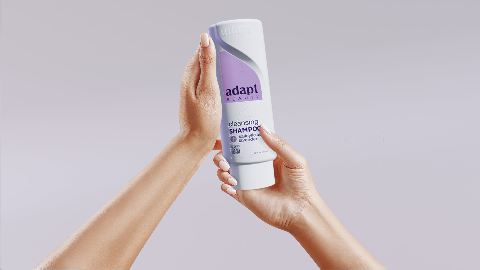 Person holding a bottle of Adapt shampoo against a plain background